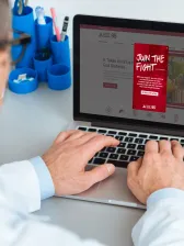 Doctor at laptop computer about to donate money to ADA