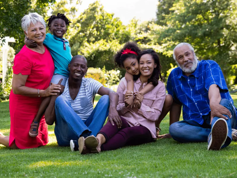 Smiling multiracial and multigenerational group on lawn